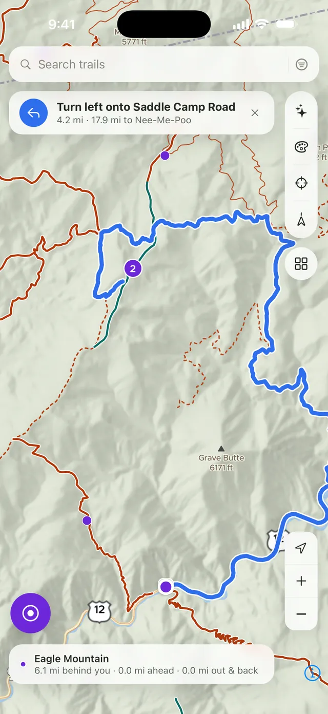 Turn-by-turn navigation in Huck, with a maneuver banner and the route drawn over forest roads.